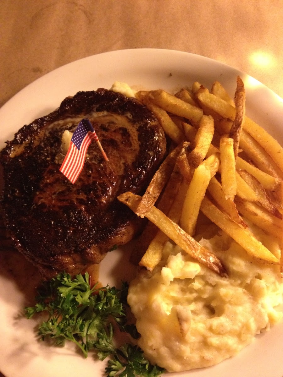 Bison ribeye, fries and garlic mashed potatoes